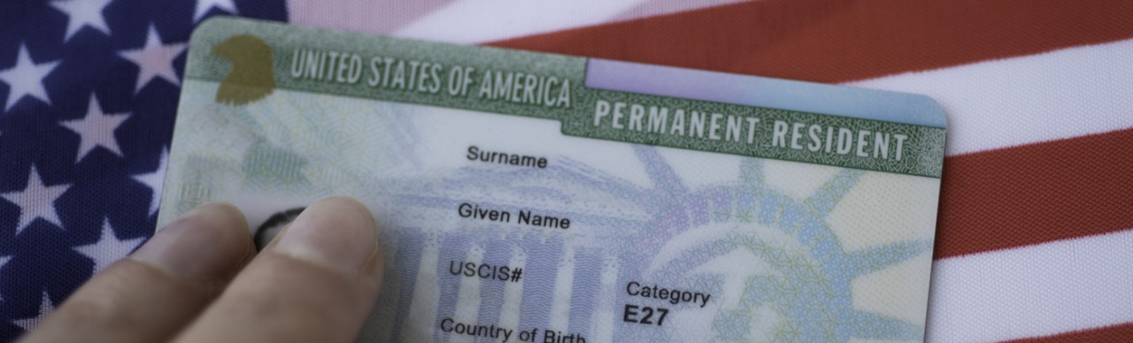 United States of America Permanent Resident Green card on flag background