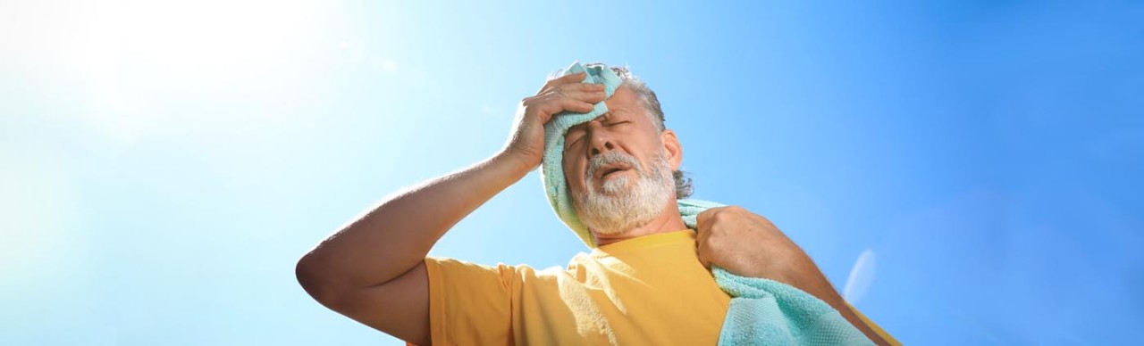 man sweating under an intense sun