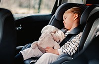 sleeping little girl in car seat